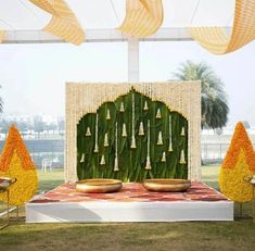 an outdoor stage decorated with yellow and orange decorations