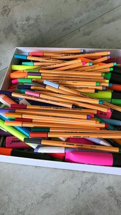 a box filled with lots of different colored pencils