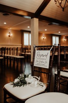 the reception room is set up with chairs and signs