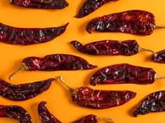 red peppers are arranged on an orange surface