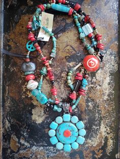 "Turn on the heat... wear awesome art jewelry!  This unique necklace has a large turquoise and coral custom pendant.  It is complimented by a array of turquoise and coral. I have also added in onyx, glass,sterling and wood. A funky lamp work  and a paper wrapped bead add to the uniqueness. The clasp has been made from a vintage pool ball. So cool.  Be you..why play by the house rules? 23\" from end to end. In a hurry to play? No problem...I ship fast. Item # 525 Your jewelry should always make y Artistic Blue Jewelry For Festivals, Turquoise Handmade Amulet Necklace, Artistic Blue Necklaces For Festivals, Artistic Blue Necklace For Festivals, Spiritual Turquoise Pendant Necklace For Festival, Unique Turquoise Jewelry With Gemstone Beads, One Of A Kind Spiritual Turquoise Pendant Necklace, Unique Hand-strung Turquoise Jewelry, Spiritual One-of-a-kind Turquoise Pendant Necklace