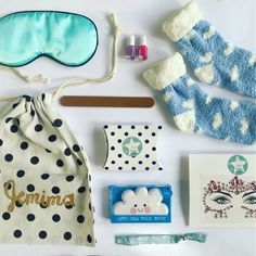 the contents of a sleeping mask and accessories laid out on a white surface with blue eyeshades