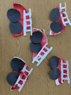 four pieces of paper cut out to look like ladders and heart shapes on a wooden table