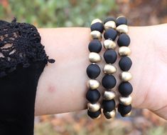 "PLEASE read ENTIRE listing BEFORE purchasing These gorgeous custom watch bands are the perfect arm candy for your Apple Watch! Each band is crafted with gorgeous matte black and distressed gold beading and hardware on a stretch band. Choose between petite or chunky beads and you're ready to rock your arm stack, watch in tow! MEASUREMENTS: *These bands fit 38mm and 40mm Apple Watch faces ONLY and are ONE SIZE to fit an average sized wrist. *I do NOT offer custom sizes, so please be sure that thi Black Beaded Bracelet With Round Beads, Arm Stack, Beaded Watches, Apple Watch Faces, Stretch Band, Chunky Beads, Stretch Bands, Custom Watch, Watch Faces