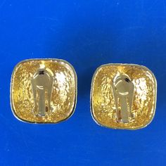 "Nice clip on earrings. Gold colored metal alloy earrings & very shiny. They are square & domed. The faces are textured that look like braiding. They measure 1 1/8\" x 1 1/8\". Nice, shiny earrings that are ready to wear. FREE SHIPPING is USPS First Class mail to the U.S. See my other listings for more clip on earrings. Thanks for looking!" Gold 14k Clip-on Earrings, 14k Gold Polished Finish Clip-on Earrings, Gold-tone Metal Clip-on Earrings Tarnish Resistant, Gold Plated Clip-on Earrings With Polished Finish, Tarnish Resistant Gold-tone Brass Clip-on Earrings, Shiny Earrings, Alloy Earrings, Square Earrings, Fashion Earrings