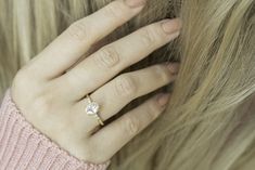 a close up of a person's hand with a ring on their finger