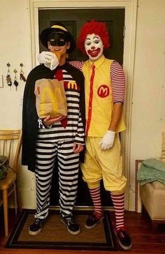 two people dressed as clowns standing in front of a door with one holding a bag