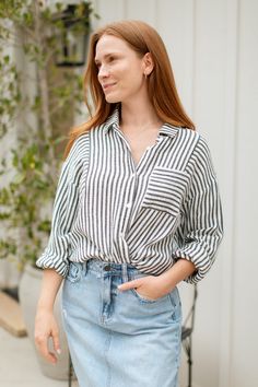 Stay cool and stylish this summer with our Zuma Button Down, featuring pretty iridescent buttons and a raw hem. This super lightweight top offers an effortless, relaxed, and roomy fit, making it perfect for warm weather. Best of all? Its 100% cotton! Wear it buttoned up for a polished look or unbuttoned over a swimsuit or tank for a breezy, casual vibe. This versatile piece is a must have summer staple! Malibu Collection FIT Relaxed Roomy Fit Iridescent Buttons High-Low Raw Hem Clancy is 5'9 Wea Chic Tops With Frayed Hem And Relaxed Fit, Chic Relaxed Fit Top With Frayed Hem, Relaxed Everyday Tops With Button Closure, Relaxed Fit Shirt With Shirttail Hem For Day Out, Chic Everyday Blouse With Shirttail Hem, Chic Blouse With Shirttail Hem For Everyday, Casual Tops With Button Cuffs And Relaxed Fit, Relaxed Button-up Shirt For Day Out, Relaxed Fit Blouse With Button Cuffs For Day Out