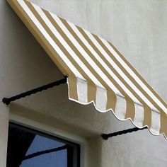 an awning on the side of a building with a window in front of it