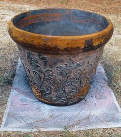 an old planter sitting on top of a towel in the middle of a field