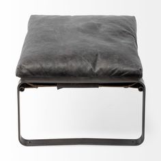 a black leather ottoman with metal frame legs and footrests, on a white background