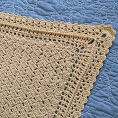 two crocheted doilies on a blue quilt