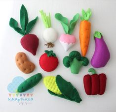 felt vegetables are arranged on a white surface