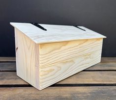 a wooden box sitting on top of a wooden table