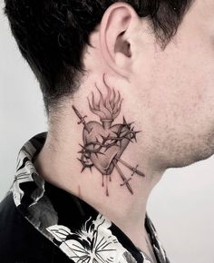 a man with a tattoo on his neck has a heart and arrows behind him,