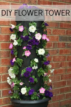 a flower tower with flowers growing on it and the words diy flower tower above it