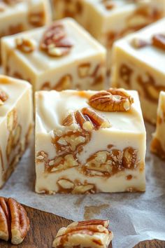 several pieces of white chocolate with pecans on top