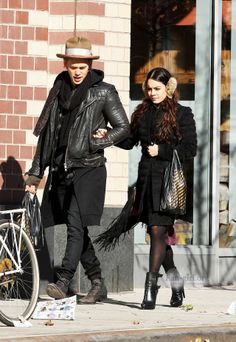 a man and woman walking down the street