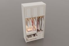 an open white cabinet with clothes hanging on it