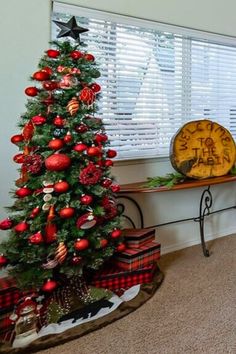 a decorated christmas tree sitting next to a window