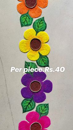 colorful felt flowers are arranged in a row