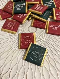 a pile of christmas chocolates sitting on top of a bed