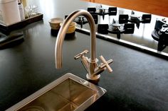 a kitchen sink with a faucet next to it on top of a counter