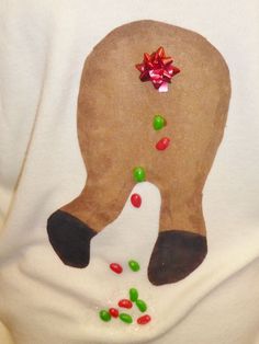 a person wearing a white shirt with a reindeer's nose and candy on it