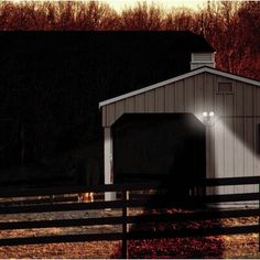 a barn with a light shining on it