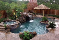 a backyard with a pool, waterfall and gazebo