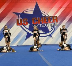 a group of cheerleaders perform on the floor in front of an american flag