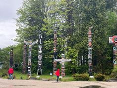 several totem poles in the middle of a park