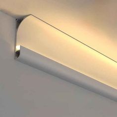 a light that is on the side of a wall in a room with white walls