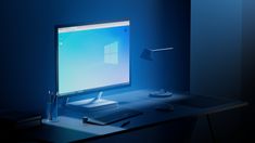 a desktop computer sitting on top of a desk next to a keyboard and mouse in a dark room