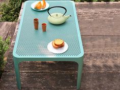 a table that has some food on it and two cups sitting on top of it