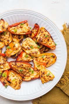 a white plate topped with chicken and peppers