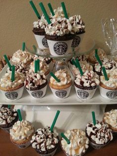 cupcakes with marshmallows and chocolate frosting are arranged on a tray