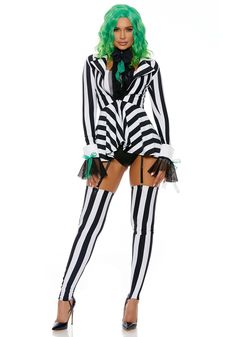 a woman dressed in black and white striped clothes with green hair wearing a costume that has stripes on it