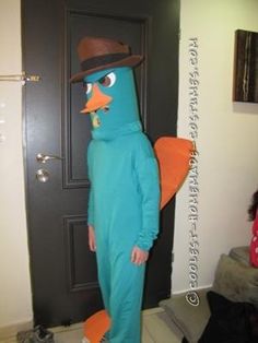 a man in a blue bird costume standing next to a door