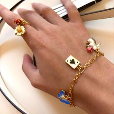 Unlock the secret of timeless style with Secret Garden Rabbit Bracelet. Meticulously crafted with an elegant poker charm and subtly lustrous enamel, this exquisite adornment is the epitome of tasteful luxury. A heartfelt addition to any jewelry collection. DETAILS Plating: 18K Gold Materials: 18K Gold on Brass, Enamel Size:  8.03 "/20.4cm Weight:  10.1g Hypoallergenic design Rabbit Bracelet, Unique Gift Wrapping, Cat Ring, Bee Necklace, Bee Earrings, Cat Necklace, Cat Earrings, Nature Jewelry, Tassel Earrings