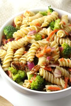 a white bowl filled with pasta and vegetables