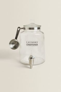 a glass jar with a spoon in it and a label on the lid that says laundry conditioner