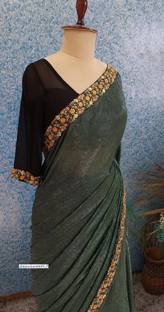 Color : Bottle Green with Shimmer Stripes Fabric - Polyester with multicolor embroidered border Blouse : Black Georgette Blouse (Made to Measure) Underskirt Included The blouse and petticoat will be stitched as per the measurements provided IF YOU WISH TO PURCHASE THIS WE CAN SEND A VIDEO ON YOUR WHATSAPP NUMBER FOR BETTER UNDERSTANDING OF THE SAREE PLEASE NOTE: BUYERS ARE RESPONSIBLE FOR ANY CUSTOMS AND IMPORT TAXES THAT MAY APPLY. Fabric Care : Dry Clean Only Disclaimer: The actual color of the product might slightly differ from the image due to photographic lighting or monitor's display Shipping: In case you are opting for stitched blouse and petticoat, once you place the order we will provide you with a template for measurements (to be taken in inches). It usually takes a week's time f Designer Green Pre-draped Saree With Embroidered Border, Festive Green Pre-draped Saree With Embroidered Border, Bollywood Style Georgette Blouse With Embroidered Border, Bollywood-style Georgette Blouse With Embroidered Border, Designer Green Pre-draped Saree With Floral Embroidery, Festive Green Pre-draped Saree With Floral Embroidery, Festive Georgette Blouse With Embroidered Border, Semi-stitched Georgette Blouse With Embroidered Border, Multicolor Embellished Pre-draped Saree For Festive Occasions