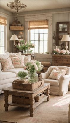 a living room filled with lots of furniture and flowers on top of a coffee table