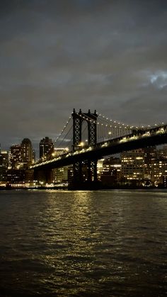 a bridge that is over some water at night