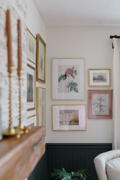 a living room with pictures on the wall and a couch in front of it's window