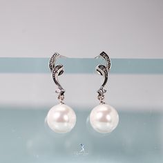 Enhance your style with these stunning sterling silver pearl dangle drop earrings! The elegant design features glistening cubic zirconia for a touch of sparkle. Perfect for any occasion, these earrings will elevate your look and make you feel confident and glamorous! Sold as a pairMaterials: 925 sterling silver, shell pearlsFinish: platinum plate, oxidationDimensions: 1.06 x 0.25 in Jewelry Care: See more information about how to care for your jewelry here. Shipping Policy: Orders will be shippe Luxury Sterling Silver Dangle Pearl Earrings, Long Drop Sterling Silver Pearl Earrings With Charm, Silver Sterling Silver Clip-on Earrings With Pearl Drop, Nickel-free Silver Dangle Pearl Earrings, Silver Sterling Silver Pearl Drop Clip-on Earrings, Silver Jewelry Earrings, Handmade Fashion Jewelry, Elevate Your Look, Screw Back Earrings