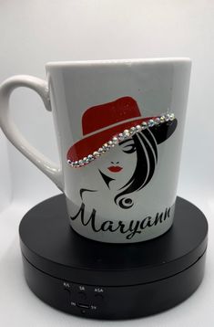 a coffee cup with a red hat on it