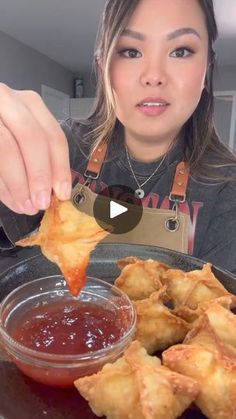 a woman is holding up some food in front of her