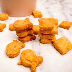 some fried food on a table next to a cup